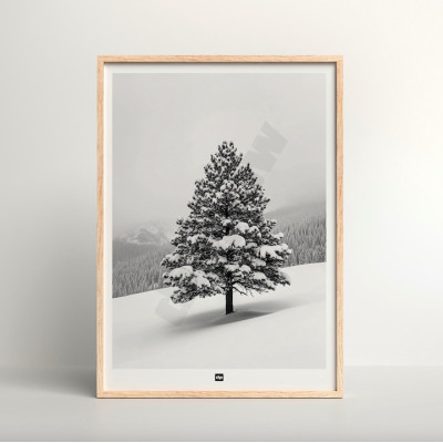 Black and white photo of a fir tree in a snowy mountain landscape. Modern, designer winter wall hanging.