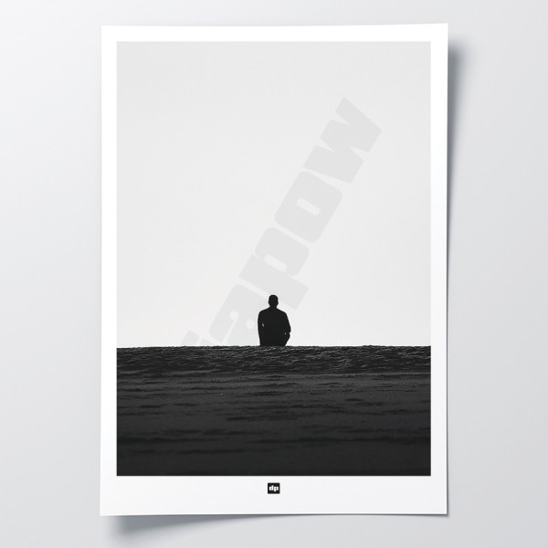 Black and white photo of a man gazing at the endless horizon. A designer wall poster with a seaside theme.